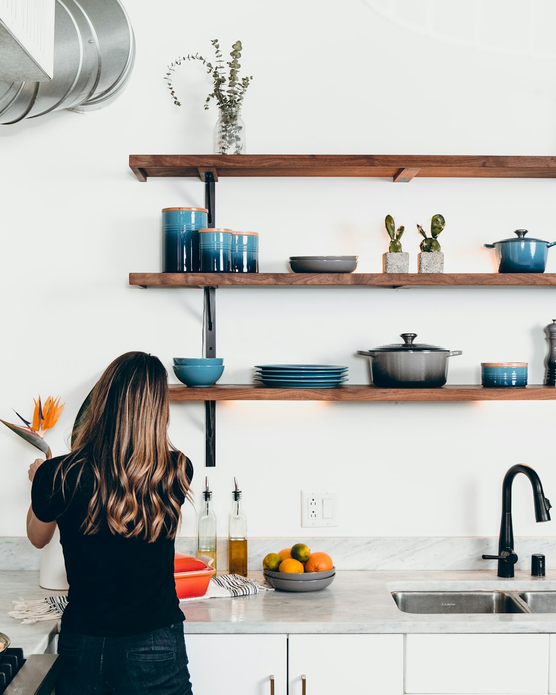 gallery-1 woman-standing-in-front-of-kitchen-sink-1wfxk3wjxzu